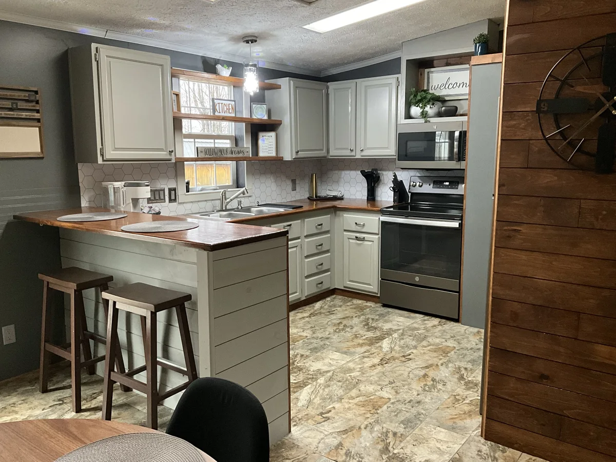 Kitchen at The Auburn with island seating and full appliances